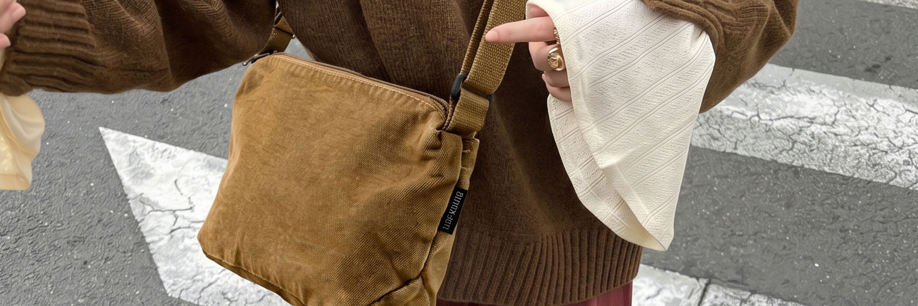 Woman Carrying Brown Canvas Crossbody Bag While Walking in the City
