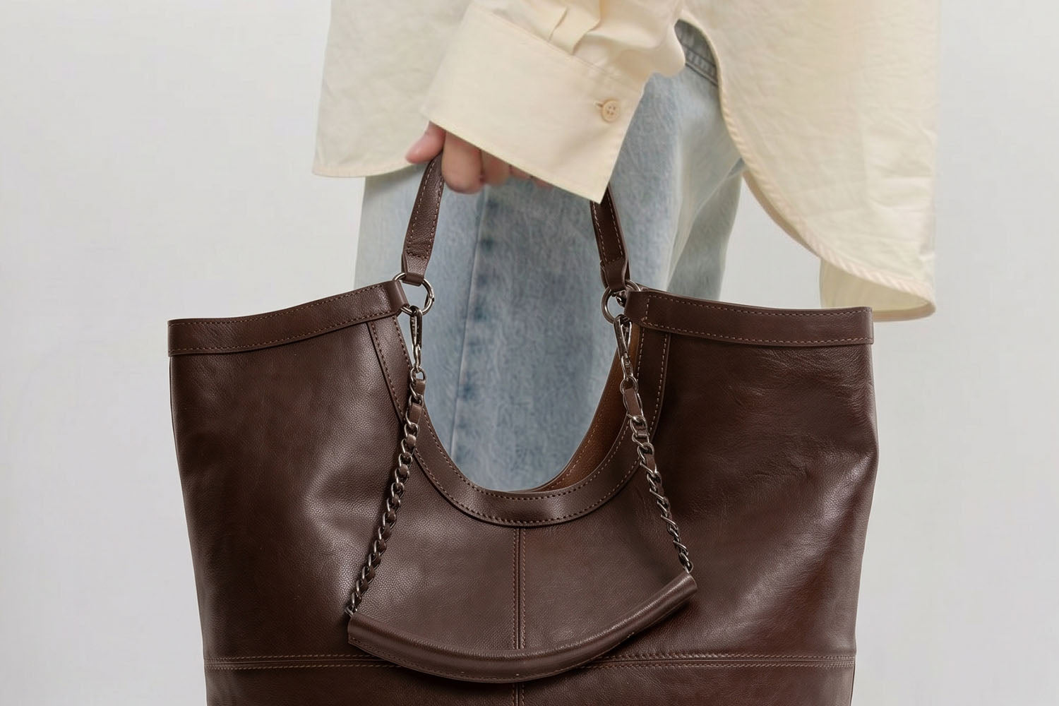 Side View of Brown Leather Tote Bag Showing Depth and Strap