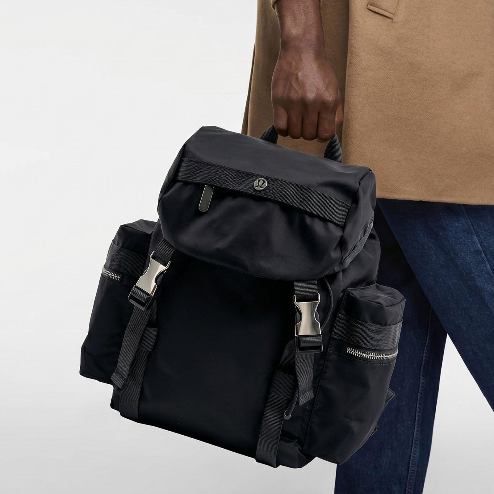 A Casual Outfit Paired with a Black Nylon Outdoor Backpack—Convenient, Lightweight, and Unisex.